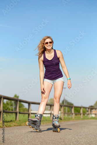 Skating woman on rollerblades in park.  © Stocked House Studio