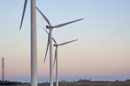 a group of 3 wind turbines standing ready for a new day of clean energy