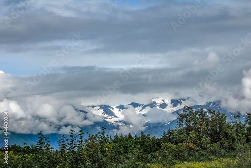 Alaska mountain ridge with sun and clouds Valdez photo