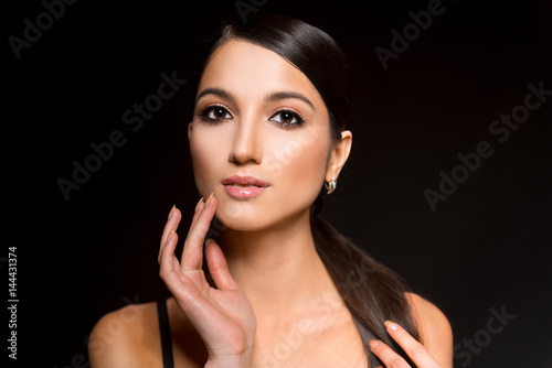 Portrait of Young Beautiful Japanese Woman with Bright Make Up, Long Hair, Clean Skin and big Eyes. Fashionable Poses in Studio on Black Background. Close Up