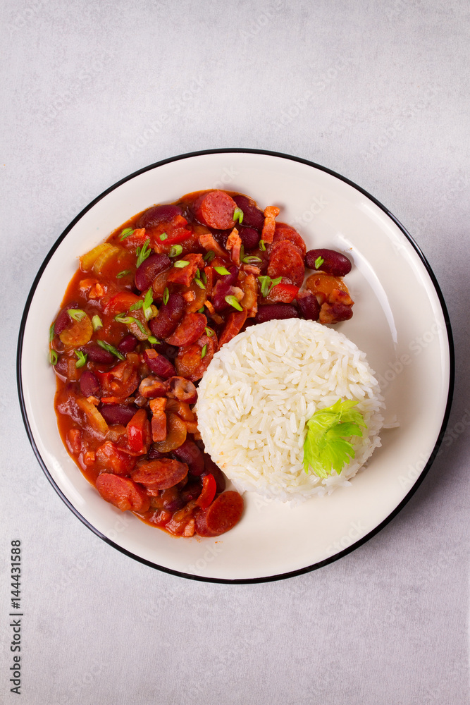 Red Beans with Sausages, Pancetta, Celery Stalks and Rice. View from above, top studio shot Red Beans with Sausages, Pancetta, Celery Stalks and Rice. View from above, top studio shot