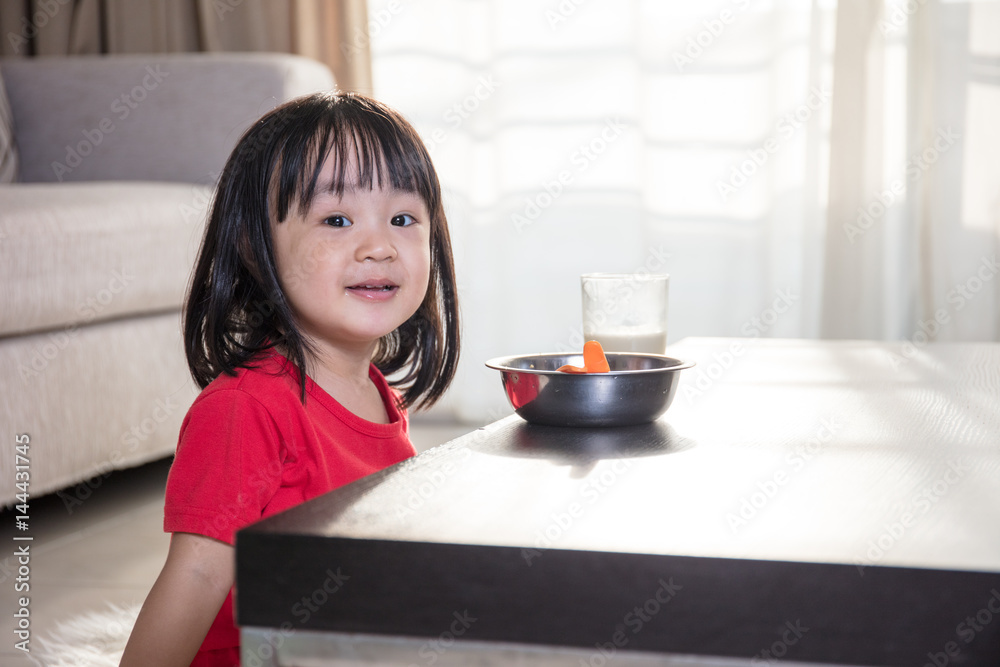 Asian Chinese little girl having breakfast with milk Asian Chinese little girl having breakfast with milk