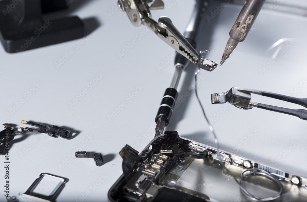 Close up of a repair smartphone with laboratory instruments