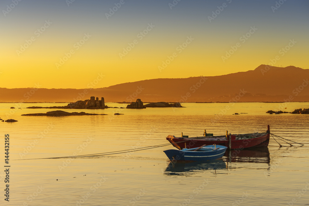 Anchored boats at sunset