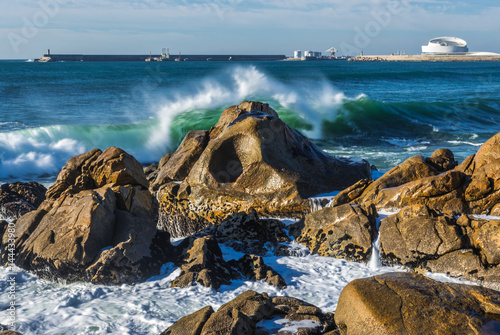 Rocks of Atlantic Ocean seen from beach in Porto, Portugal photo