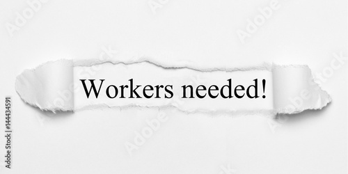 Workers needed! on white torn paper