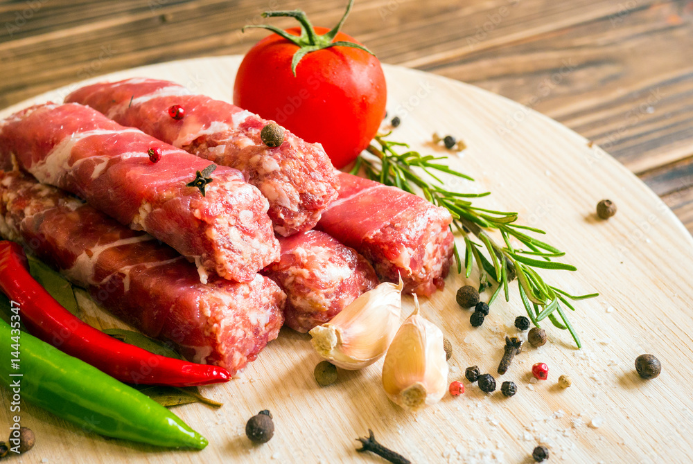 Raw cevapcici dish of mixed meats, the food of the Balkans. Minced meat and bacon.