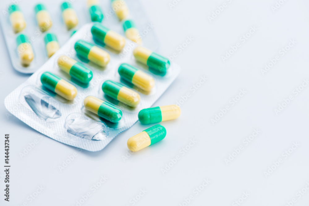 Pile of scattered capsules on a white background Pile of scattered capsules on a white background