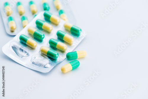 Pile of scattered capsules on a white background