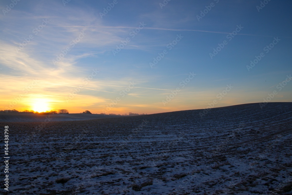 Hilly landscape at sunrise and blue sky in February Hilly landscape at sunrise and blue sky in February