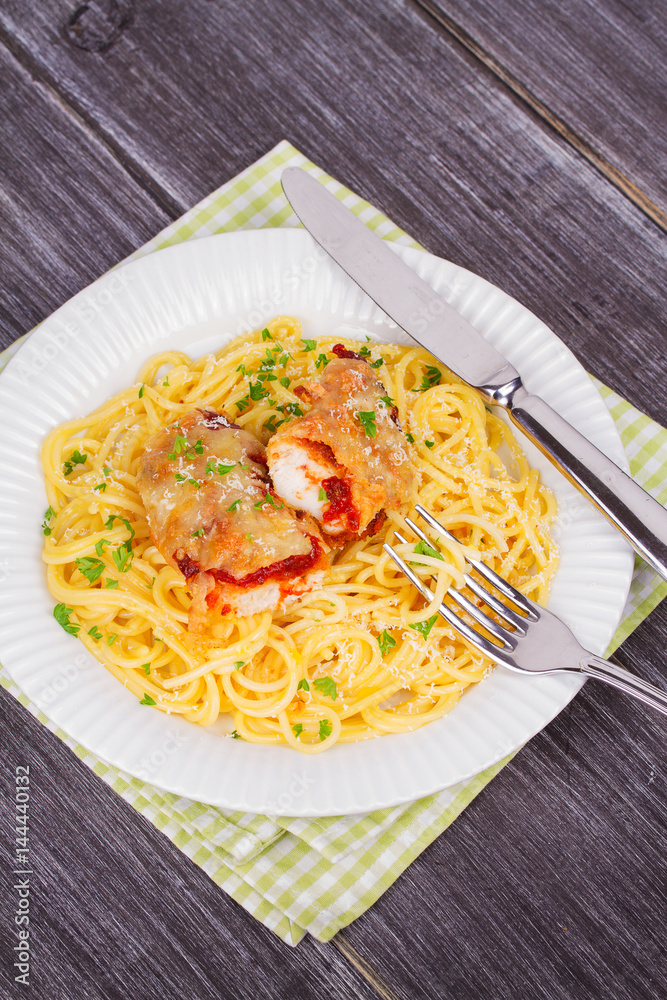 Chicken parmesan and pasta. Chicken breasts and spaghetti. View from above, top studio shot Chicken parmesan and pasta. Chicken breasts and spaghetti. View from above, top studio shot