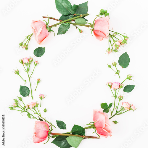 Floral round frame with pink rose, leaves and buds on white background. Flat lay, top view. Frame background