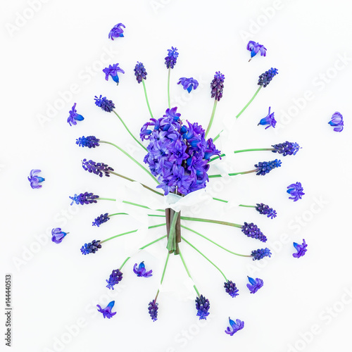 Fototapeta Naklejka Na Ścianę i Meble -  Bouquet of hyacinth with tapes and pattern of muscari on white background. Flat lay, top view.