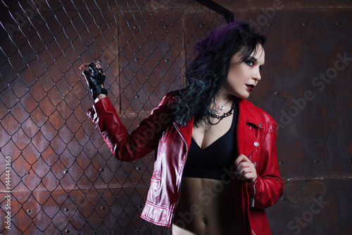 Aggressive punk woman, in red leather jacket