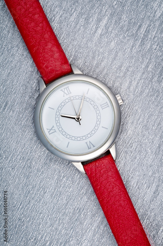 Closeup classic woman wristwatch with red leather bracelet