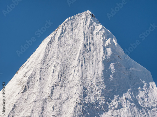 Peak Jambeyang with blue sky background, Daocheng Yading National Park, Sichuan, China. photo