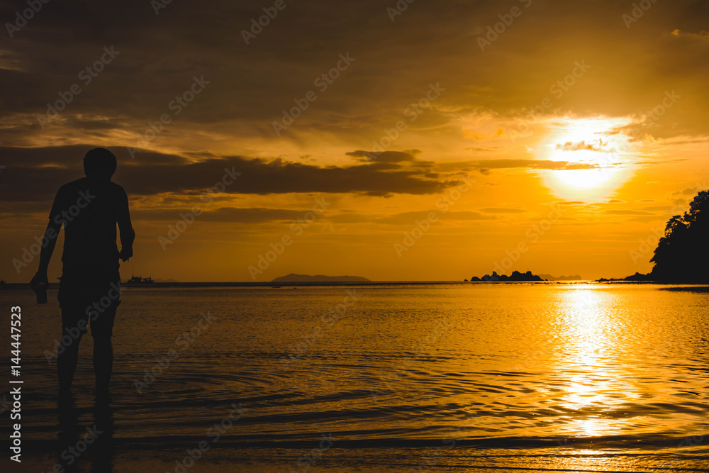 man and sea at sunset