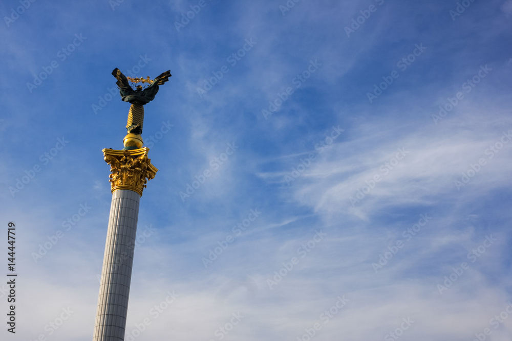 Statue architecture monument at Independence Square in Ukraine capital city Kiev isolated blue sky with clouds
