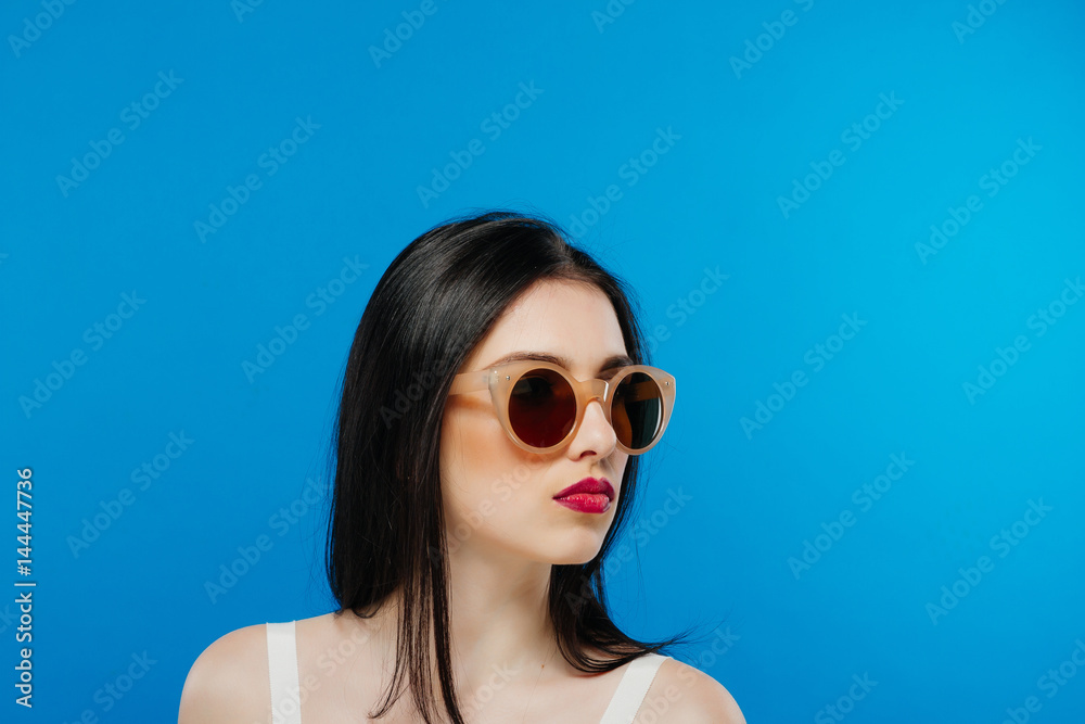 custom made wallpaper toronto digitalSide View of Female Face with Clean Perfect Skin and Fashion Sunglasses on Blue Background.