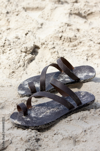 Made to order sandals on the sand at the beach.