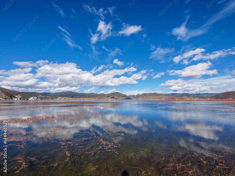Landscape of beautiful Napa lake and cloud reflection in the water, shangri-la county ,yunnan province,china.