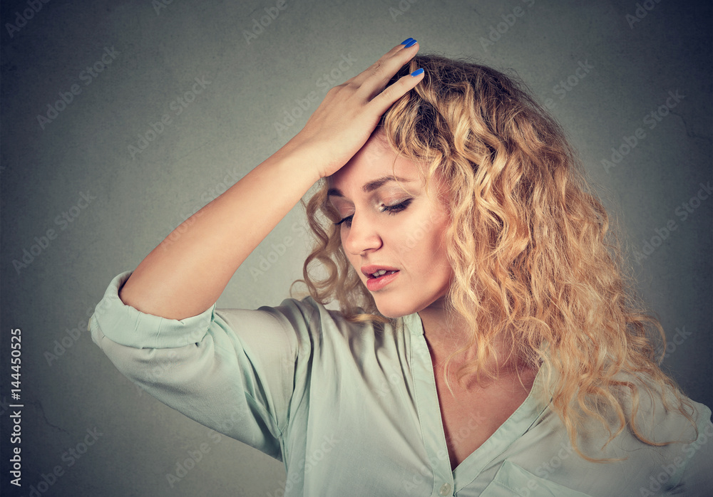 sad woman with worried stressed face expression looking down