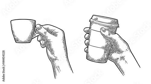 Hand holding a disposable cup of coffee with cardboard holder and cap.