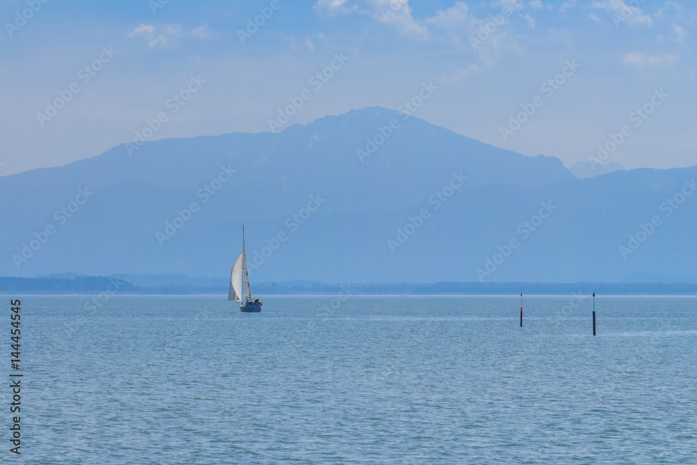 Sailing boat on Lake Chiemsee, Bavaria on a sunny spring day