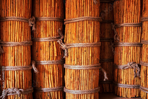 many sheaves, bundles tied long sticks of cinnamon collected for shipping in the factory