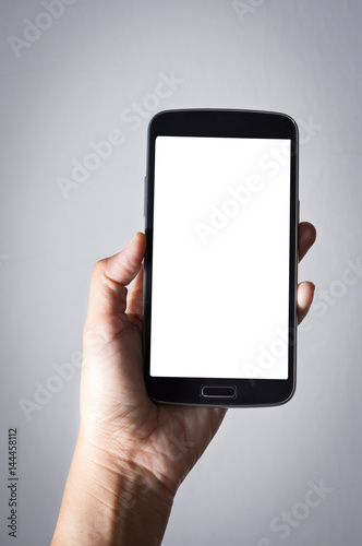 Smartphone in woman hand, white screen.
