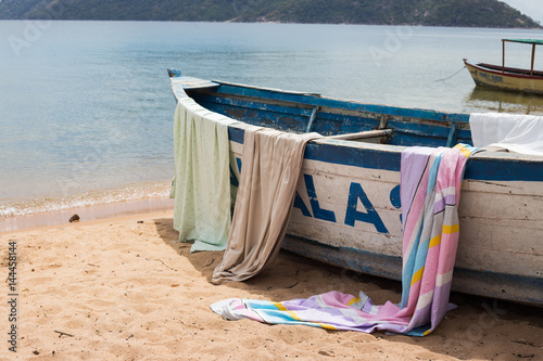 Towels on the side of a boat in a fishing village