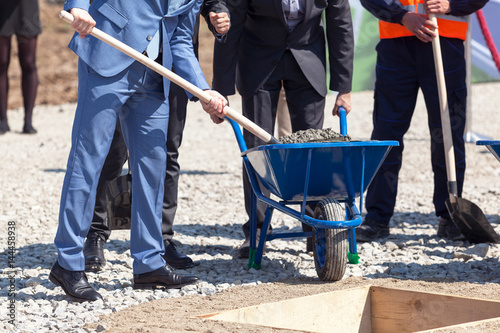 Business people at foundation stone laying ceremony for the new building photo