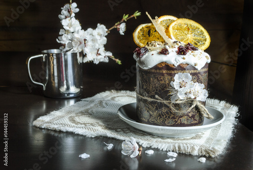 Easter cake and spring flowers on a dark background