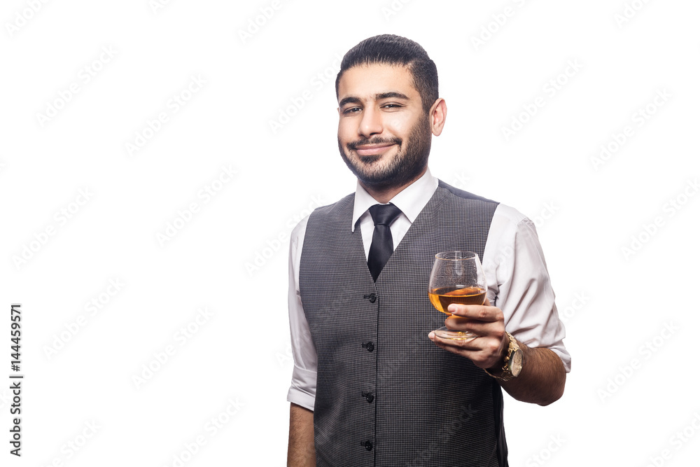 Handsome bearded businessman holding a glass of whiskey. smiling and looking at camera. studio shot, isolated on white background. Handsome bearded businessman holding a glass of whiskey. smiling and looking at camera. studio shot, isolated on white background.