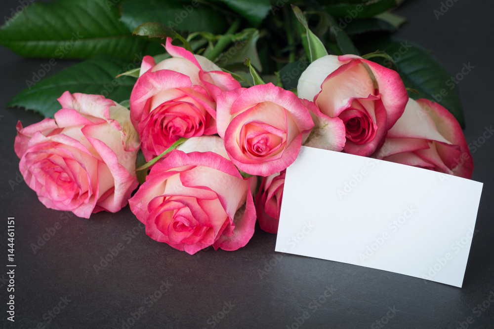 Bouquet of pink roses and empty tag with copy space. Closeup view. Mothers day, Women's day or other holidays gift mockup