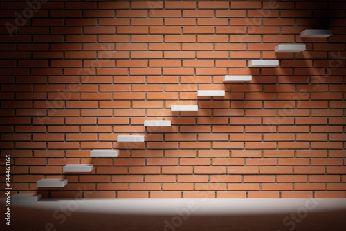 Ascending stairs in dark empty room with red brick wall