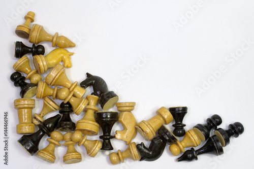 triangular set of blacks and whites chess pieces in a neat pile