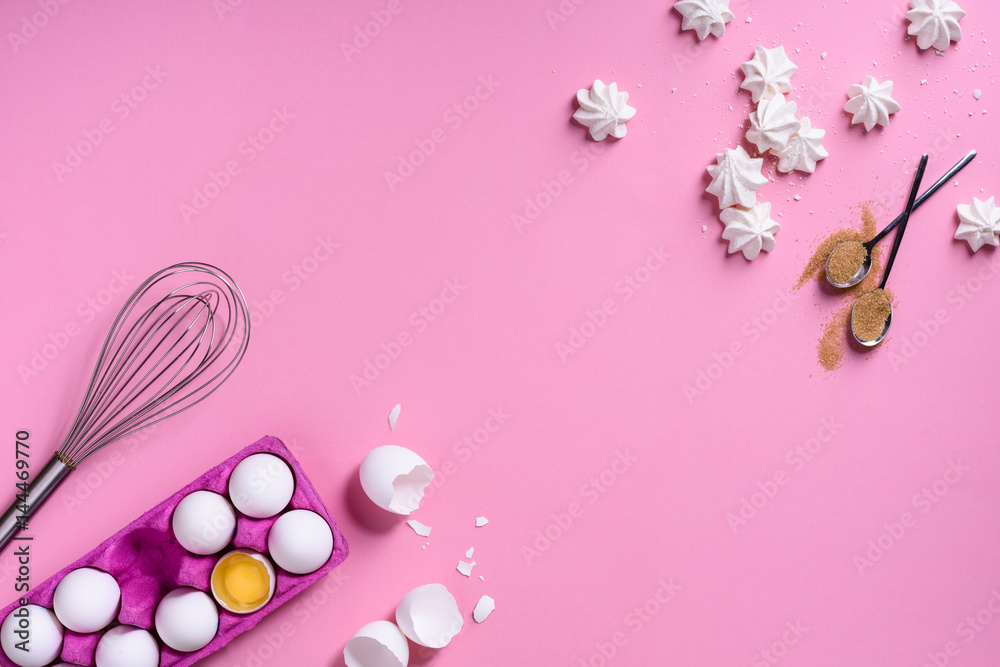 Bakery background frame. Cooking ingredients - egg, sugar, over pink background. Romantic cooking theme. Top view, copy space.