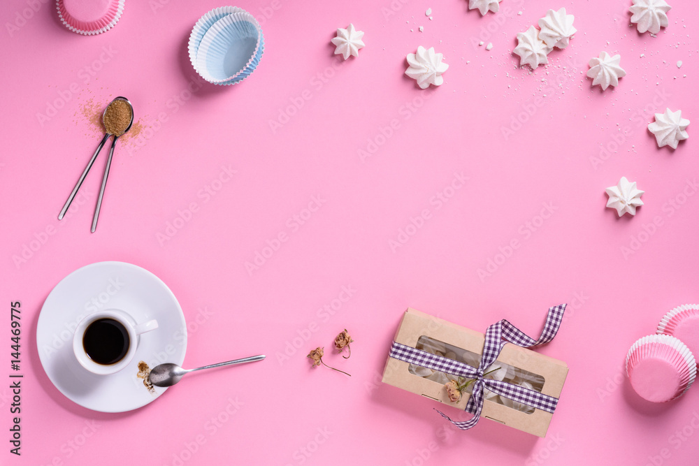 Bakery background frame. Coffee and cooking ingredients - egg, sugar, over pink background. Spring cooking theme. Top view, copy space.