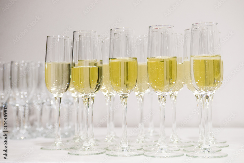 Champagne pour into glasses on the table Champagne pour into glasses on the table