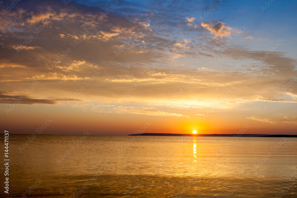 Beautiful colorful summer sea sunrise landscape with amazing colorful clouds in a blue sky in Crimea, Azov sea, Ukraine 2013.