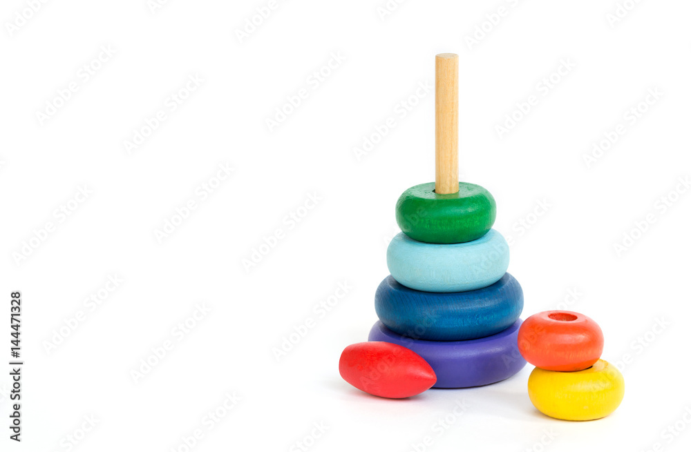 Children's multi-colored wood toy pyramid isolated on white background. Assembled Pyramid Children's multi-colored wood toy pyramid isolated on white background. Assembled Pyramid