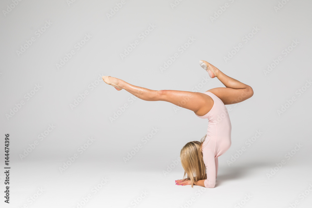 Young Beautiful Woman Gymnastics Dancer In Pink Swimsuit Posing On A Young Beautiful Woman Gymnastics Dancer In Pink Swimsuit Posing On A