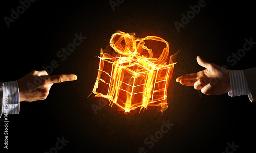 Concept of celebration with fire burning gift symbol and creation gesture