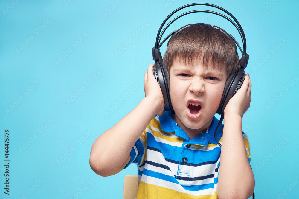 European boy listening music with headphones.