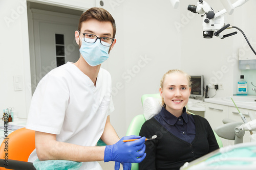 Dentist in mask and beautiful woman