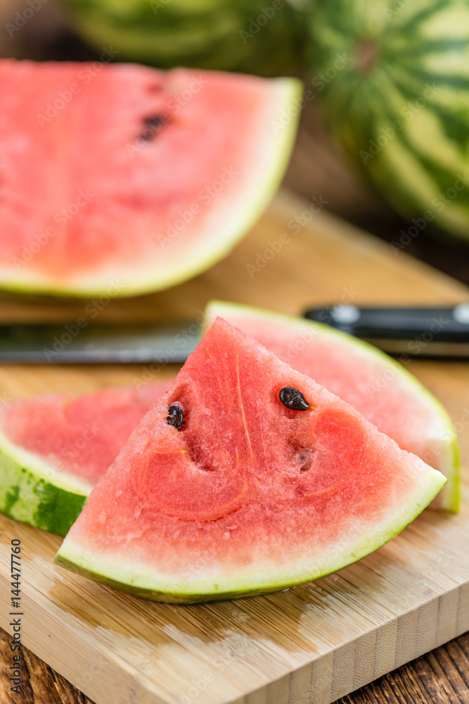 Portion of Fresh Watermelon on wooden background (selective focus). Portion of Fresh Watermelon on wooden background (selective focus).