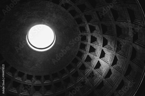 Inside view of the oculus (hole) and dome of the Pantheon in Rome in black and white.