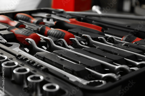 Box with special tools in car repair shop, closeup