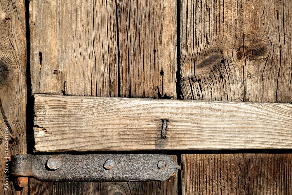 hand-forged hinges on old wooden door